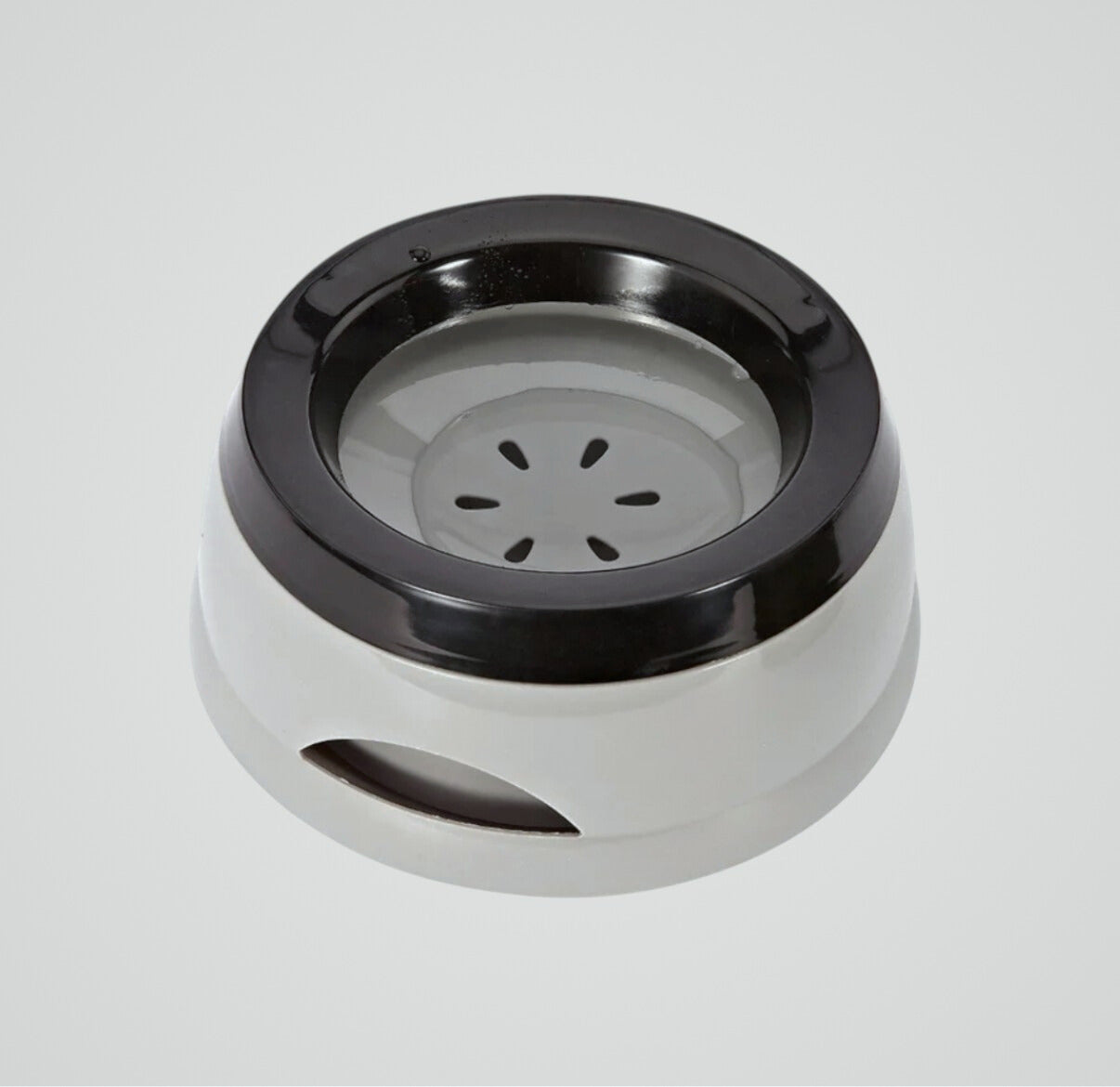 Round white and black plastic pet water bowl with a non-slip base on a gray background