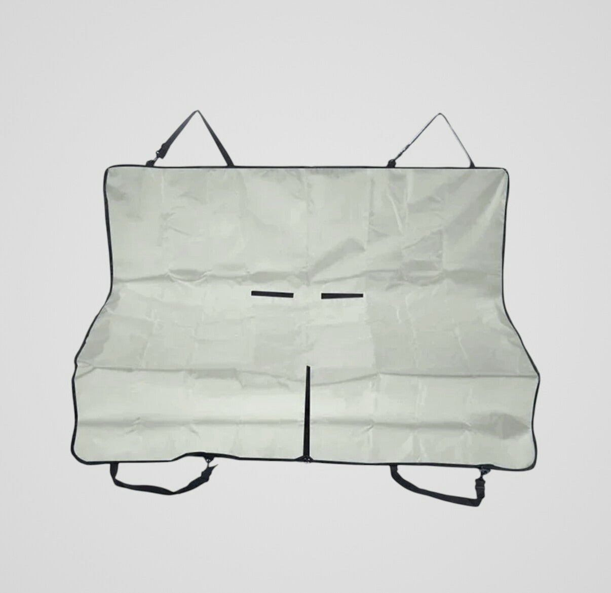 Folded light gray car seat cover with black straps on a plain background