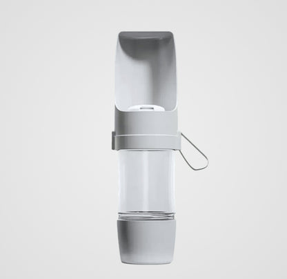 Portable gray and white pet water bottle with attached drinking bowl and silicone strap