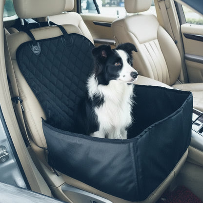 Black and white Border Collie sitting on beige car seat inside black quilted pet car seat cover
